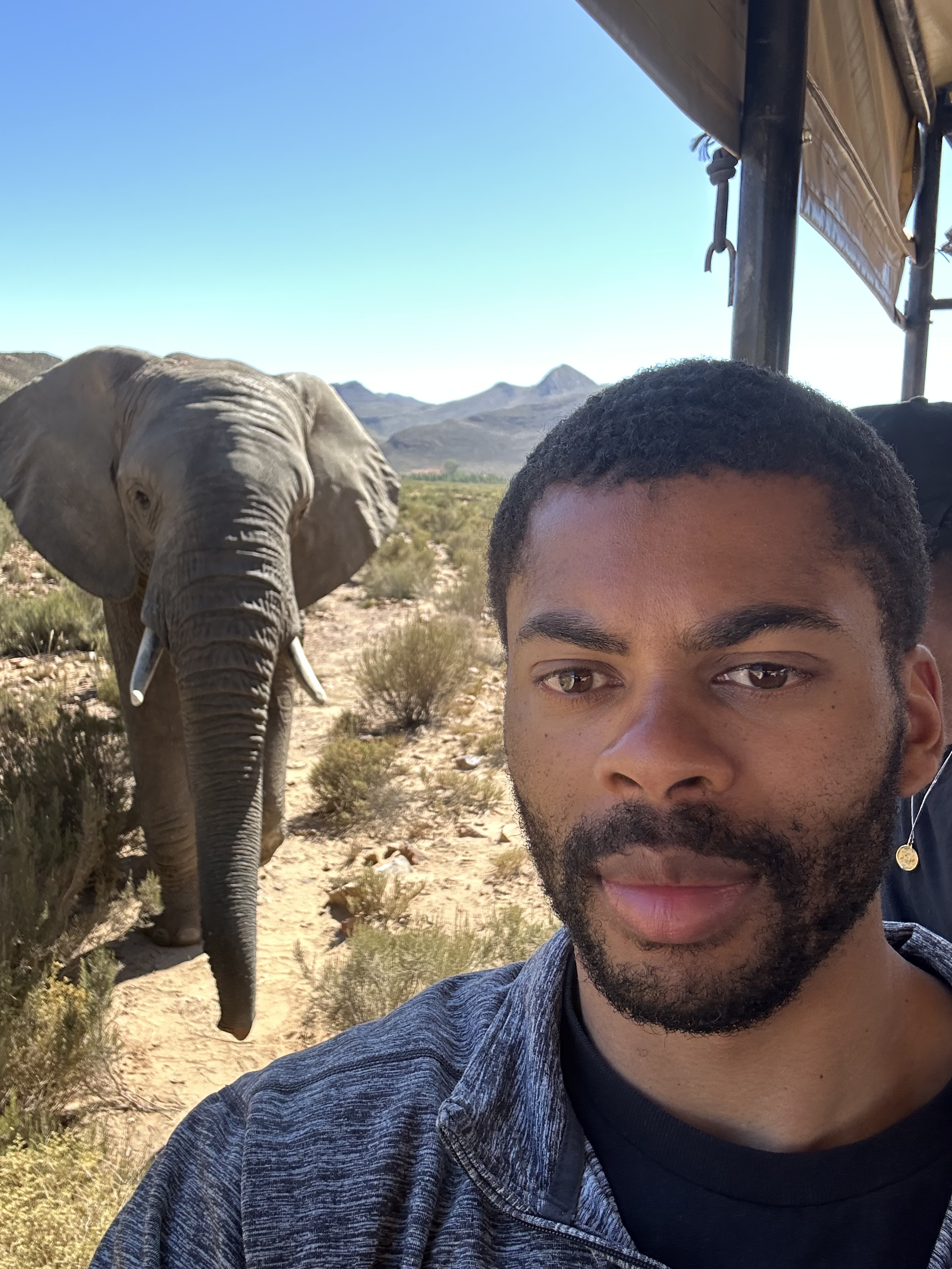 Miles Tucker on safari with an elephant in the background